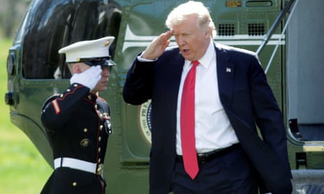 President Donald Trump salutes from the steps of the Marine One helicopter, in Washington.