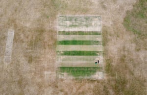A groundsman at Boughton and Eastwell cricket club in Ashford, Kent, prepares the wickets
