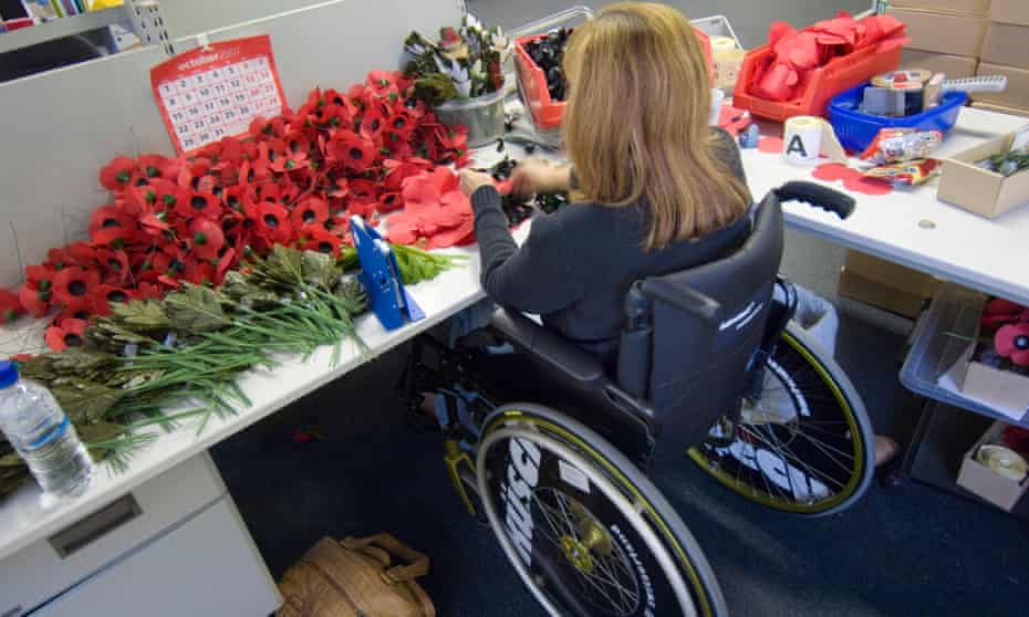 Disabled poppy maker works from her wheelchair at the British Legion Poppy factory in Surrey
