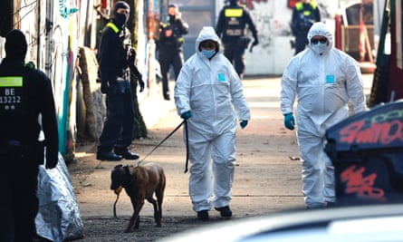 Investigators at the scene of the raid
