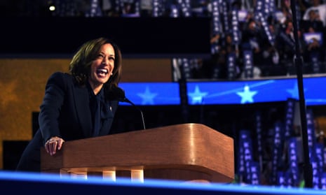 Kamala Harris grips the podium and laughs at the DNC with stars behind her