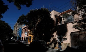 A woman walks her dog past the childhood home of director Alfonso Cuarón, who lived here in the 1970s, on Tepeji Street in the Roma Sur area of Mexico City on December 20, 2018.