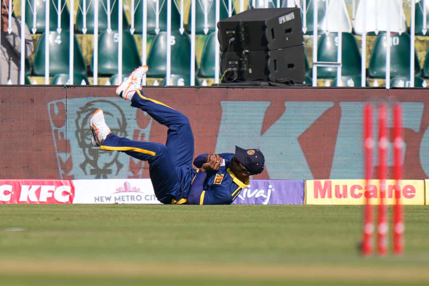 Sri Lanka's Janith Liyanage dives to take a catch near the boundary