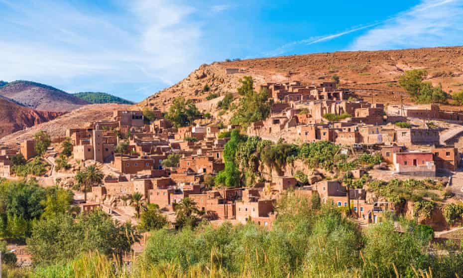 A Berber village nestled into the Atlas mountains, the buildings the same russet colour as the mountains