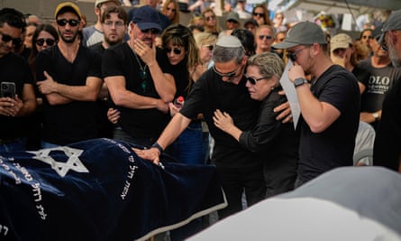 Mourners gather in grief around the bodies of Danielle Waldmann and her partner, Noam Shai, during their funeral in the northern Israeli town of Kiryat Tivon on Thursday.
