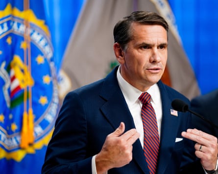 A man in a suit giving a press conference