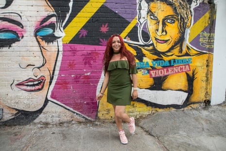 Daniela Maldonado Salamance, director of Red Comunitaria Trans, in Santa Fe in front of a wall that reads: ‘A life free of violence.’