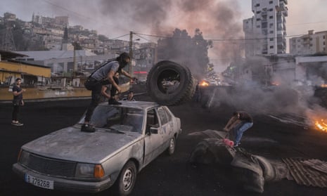 Protesters in Beirut unloading tyres to burn during unrest sparked by economic difficulties