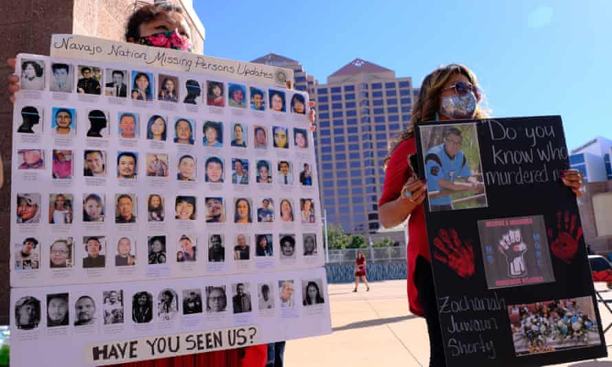 Meskee Yatsayte of Gallup, left, and Vangie Randall-Shorty of Farmington hold signs to raise awareness for missing and murdered Native Americans in Albuquerque, New Mexico, October 11, 2021.