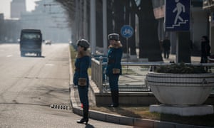 Traffic police stand at the side of a road