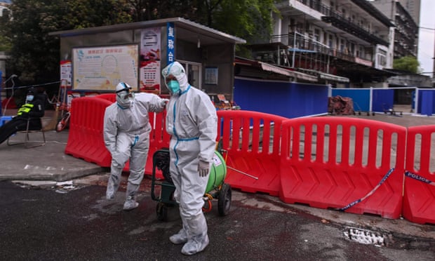 Workers in protective clothing at the Huanan seafood wholesale market in Wuhan, China, in March 2020.