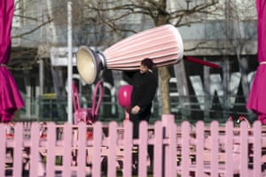 Member of staff carrying giant cocktail glass