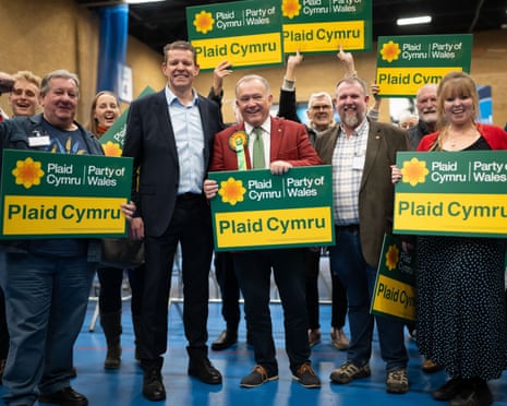 Plaid Cymru’s poll winner Lindsay Whittle (centre) and leader Rhun ap Iorwerth (centre left) celebrate the byelection win on Friday