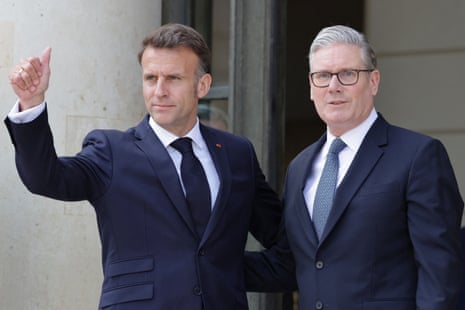 Keir Starmer and Emmanuel Macron post for photos, with Macron showing a thumbs up to cameras.