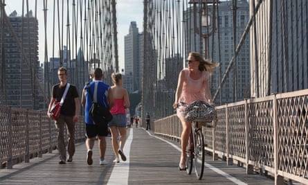 Walkers and cyclists cross the Brooklyn Bridge in New York, where many of the city’s car-centric policies were redrawn under Mayor Michael Bloomberg.