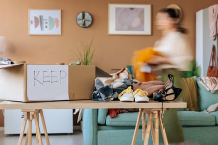 A blurred image of a woman in the process of decluttering