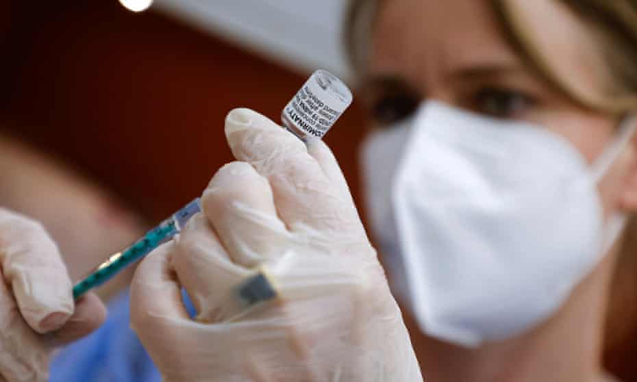 A GP preparing a dose of the Pfizer/BioNTech Comirnaty vaccine in her practice in Berlin.