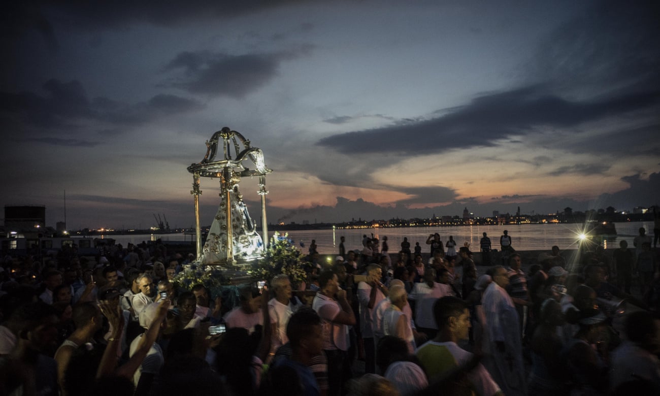 A crowd watches a procession in honor of the Virgin of Regla, in the town of Regla, across the bay from Havana, Cuba, Monday, Sept. 7, 2015. The black Madonna is honored on the same day as Cuba’s patron saint, the Virgin of Charity, both of which are also recognized as powerful deities in the African-influenced religion of Santeria. (AP Photo/Ramon Espinosa)
