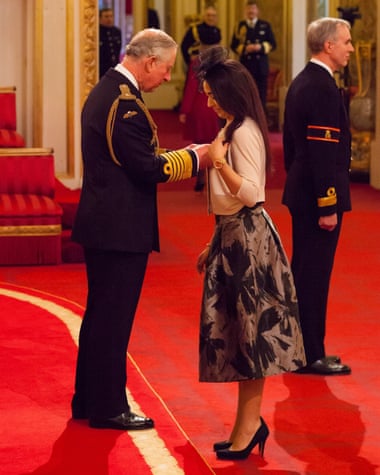 Receiving her OBE from Prince Charles.