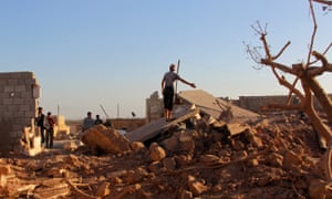 People inspect a damaged site after an airstrike on the rebel held Owaijel village, west of Aleppo city