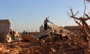 People inspect a damaged site after an airstrike on the rebel held Owaijel village, west of Aleppo city