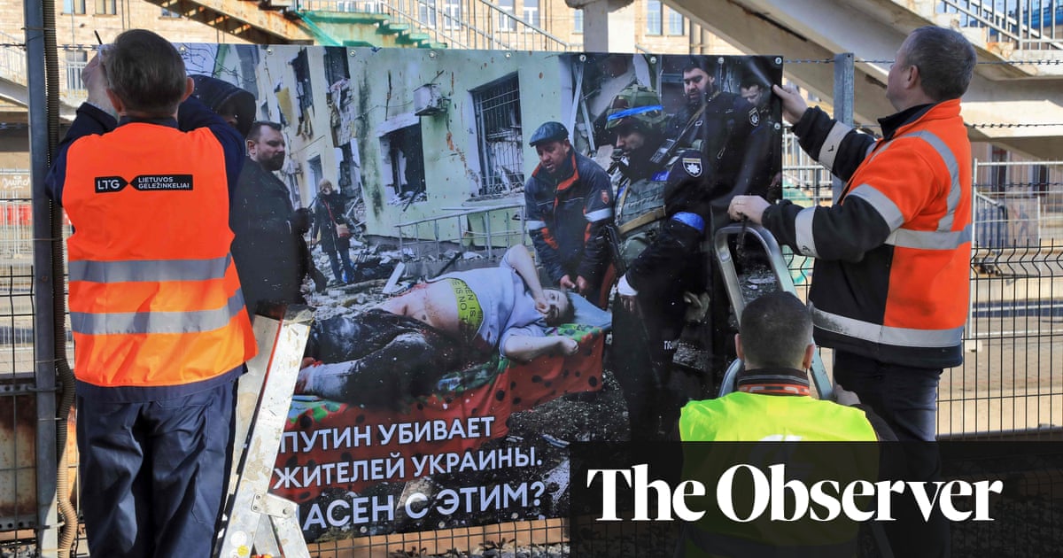 ‘Putin is killing civilians’: the train station where Russians are greeted with images of war