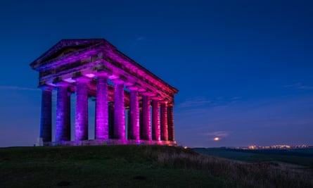 The Penshaw Monument lit up at night.