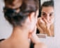 A woman looking at herself in the mirror