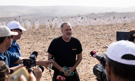 Spencer Tunick speaks after photographing his installation on Sunday.