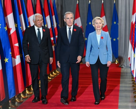 three people walk on a red carpet