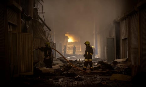 Firefighters work at storage facilities in Odesa hit during the Russian strikes