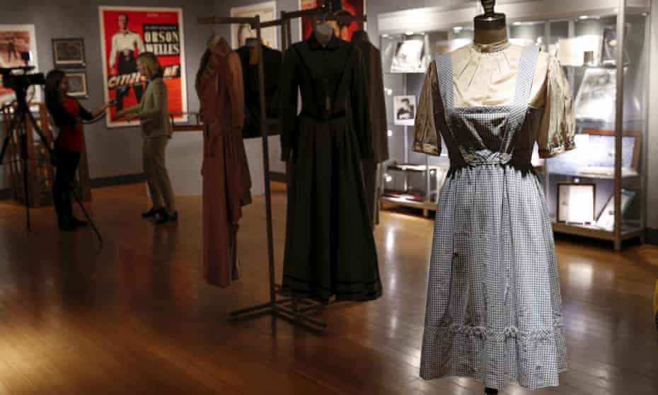 The pinafore dress worn by Judy Garland in The Wizard of Oz stands among a host of other memorabilia at Bonhams in New York.
