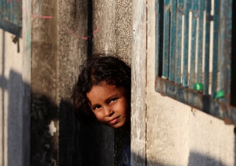 A Palestinian child displaced by the Israeli military offensive looks on from a shelter at an UNRWA school in Deir Al-Balah, in the central Gaza Strip, August 20, 2025.