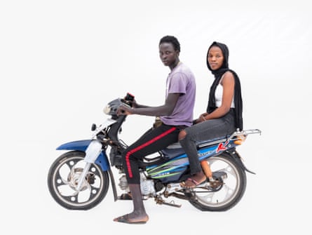 Motorcycle taxi driver Akasa and passenger Djenaba on a KTM in Thiès, Senegal