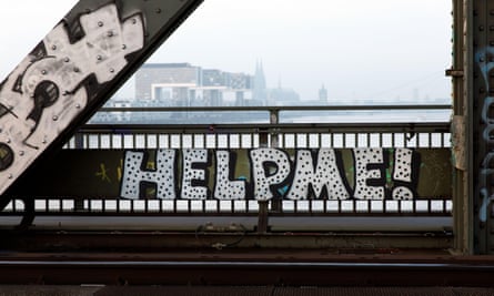A sign on a bridge barrier says: 'Help me!'