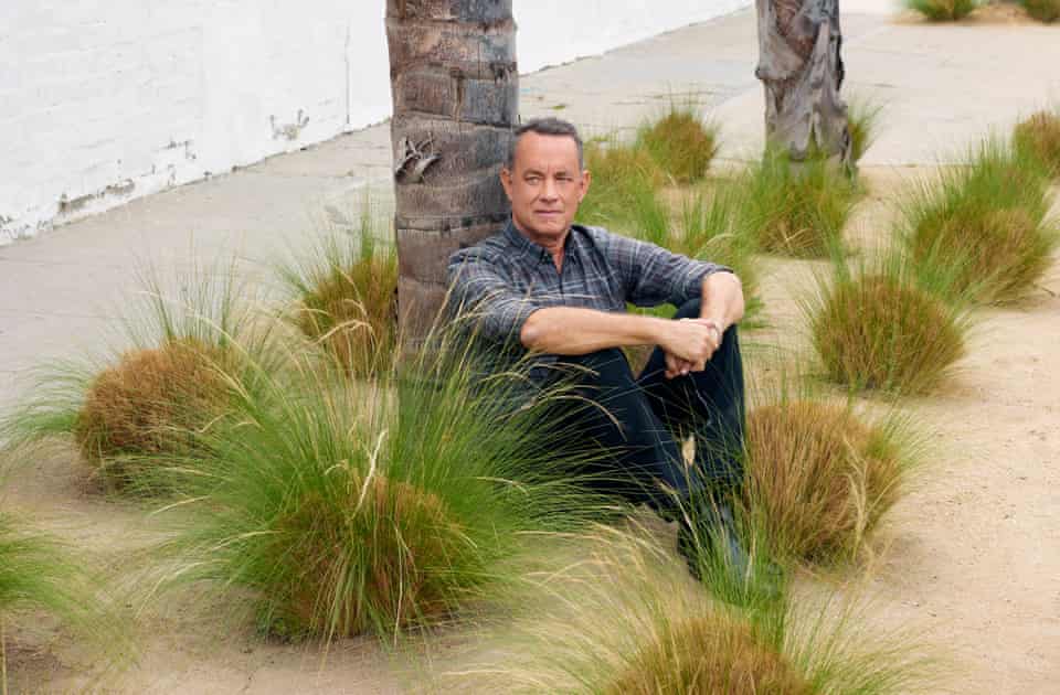 Tom Hanks sitting by a palm tree