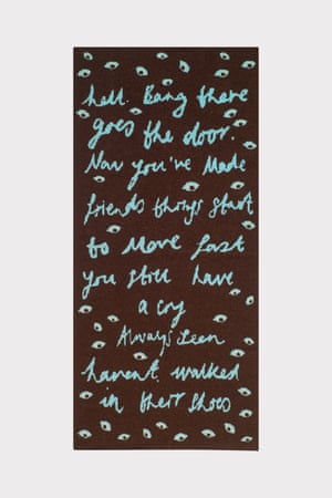 Brown blanket with a poem design in cyan