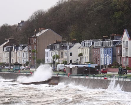 Large waves crash against a seafront