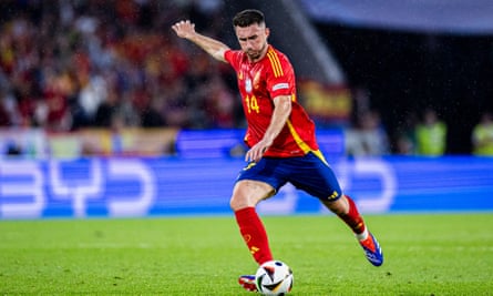 Aymeric Laporte striking a football for Spain.