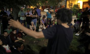 Neighbors gather to discuss the crisis in Santiago.