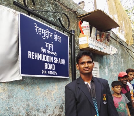 Rugby player and national women’s team coach Rehmuddin Chittasahab Shaikh standing next to his street sign in Mumbai.