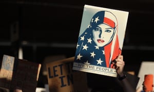 A protester holds a sign at San Francisco international airport during demonstrations against the executive order.