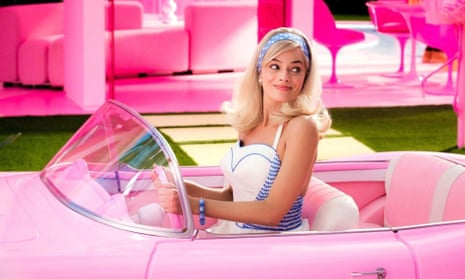 Margot Robbie as Barbie in her pink Chevrolet