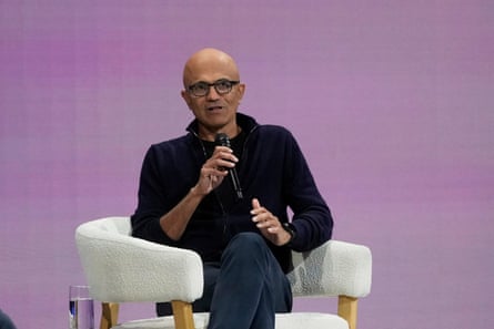 Satya Nadella on stage in a black fleece