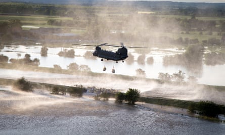 An RAF Chinook helicopter is used to try to stem the flow of water in Wainfleet, Lincolnshire during floods in 2019.