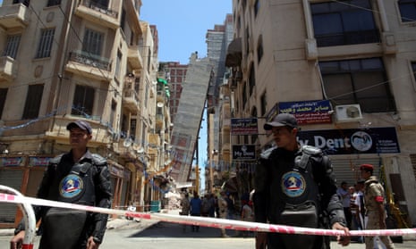 Egyptian security personnel stand guard in front of the toppled high-rise building leaning at Azarita in Alexandria.