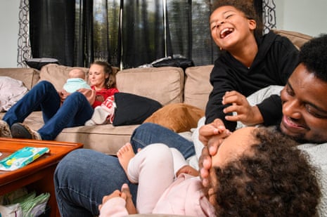 A joyful family playing on a couch