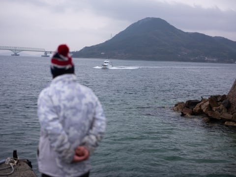 Kasasa Island coastline with fishing boats in Seto Inland Sea