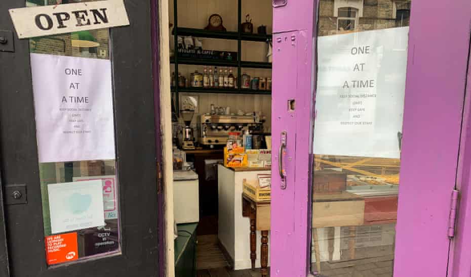 Open door to deli with social distancing signs up during coronavirus crisis (Il Molino in Battersea Park Road, London)