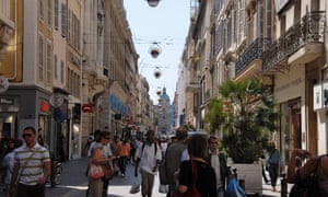 People promenade the Rue St. Ferreol boulevard in downtown Marseille